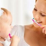 Mom and daughter brushing teeth